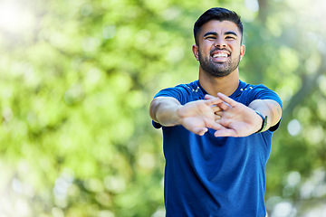 Image showing Fitness, mock up and stretching arms with a man outdoor in nature for a warm up before exercise. Workout, mockup and training with a male athlete on a natural green background for health or cardio