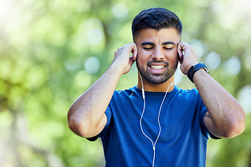 Image showing Exercise, fitness and a man listening to music with earphones outdoor at park for cardio training. Happy sports person or athlete in nature with podcast for a run and workout for health and wellness