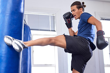 Image showing Kickboxing, fitness and sports with a man fighter training his power in a gym for a competition. Exercise, health and energy with a male kickboxer in a sport facility for a workout on a punching bag