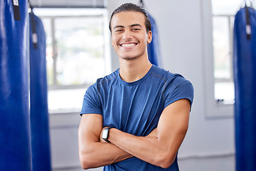 Image showing Personal trainer man, gym portrait and arms crossed with focus, wellness and health in workplace. Happy coach, smartwatch and strong mindset for exercise, mma and boxing training in workout studio