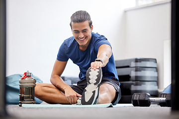 Image showing Fitness, gym or man stretching legs starting training, workout or exercise warm up to relax muscles. Wellness, flexible or healthy sports athlete with a happy smile exercising in a studio in Brazil