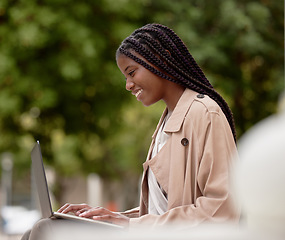 Image showing Business, city and black woman typing on laptop in street, social media or internet browsing. Remote worker, computer and happy female employee working on research, email or project in town outdoors.