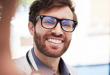 Image showing Doctor, man and selfie with smile at hospital for social media app, profile picture and happy with glasses. Medic, happiness and workplace digital photo for blog, internet or web networking in clinic