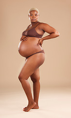 Image showing Pregnant, body and black woman isolated on studio background for beauty, skincare and abdomen health. Underwear, stomach and african model or person with pregnancy for wellness, care and self love