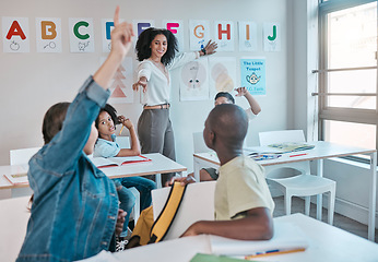 Image showing Teacher, question and woman happy for education and teaching at school with kids learning the alphabet and answer quiz. Raised hands, learners and tutor helping a clever and smart classroom