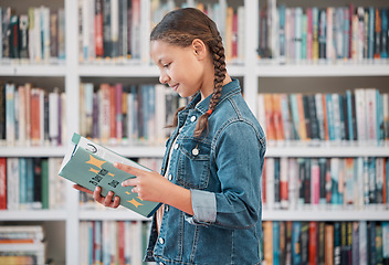 Image showing Books, education or child in a library reading for knowledge or development for future growth. Scholarship, girl or school student with a happy smile studying or learning information in a fun story