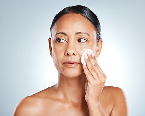 Image showing Face, beauty and woman with cotton in studio for cleaning, wellness and grooming on grey background. Facial, clean and girl with pad for toner, skincare and moisturizing skin while posing isolated