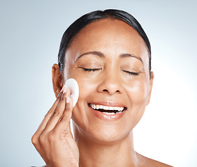 Image showing Happy, beauty and woman with cotton in studio for cleaning, hygiene and relax on grey background. Facial, pad and lady model smile for wellness, skincare and dermatology, product or cosmetic isolated