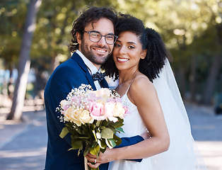 Image showing Wedding portrait and flowers of couple with hug at romantic outdoor marriage event celebration together. Partnership, commitment and trust embrace of interracial bride and groom with excited smile.