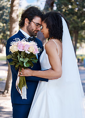Image showing Wedding, couple and marriage outdoor with commitment, trust and love with bride and groom in park. Life partner, married man and black woman with rose bouquet, content and interracial relationship