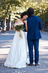 Image showing Wedding, outdoor and couple marriage celebration event for bride and groom together with commitment. Married man and woman at ceremony with trust, partnership and support with flower bouquet and hug