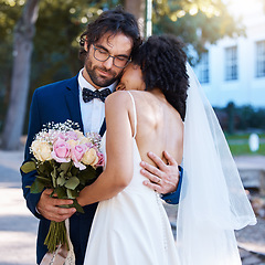 Image showing Wedding, love and couple hug outdoor for marriage celebration event for bride and groom together. Married interracial man and woman at commitment ceremony for partnership and care with flower bouquet