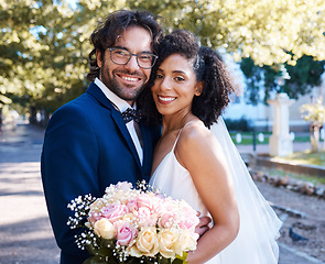 Image showing Wedding, bride and groom portrait with flowers and hug at romantic outdoor marriage event celebration together. Partnership, commitment and trust embrace of interracial people with excited smile.