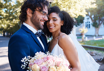 Image showing Wedding, couple portrait and happy at marriage celebration event for people together for commitment. Interracial man and woman at ceremony with trust, partnership and a hug with flower bouquet