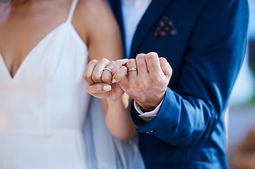 Image showing Hands, pinky promise and wedding ring of couple outdoor celebration of trust, partnership and love. Marriage commitment or loyalty of interracial bride and groom at ceremony to celebrate togetherness