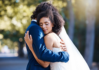 Image showing Care, hug and wedding bride with groom at romantic outdoor marriage event celebration together. Partnership, commitment and trust embrace of married interracial couple in nature with bokeh.