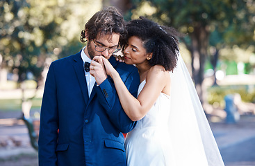 Image showing Wedding, couple and kiss while holding hands outdoor at marriage celebration event together with commitment. Interracial man and woman with trust, partnership and respect or care in nature park