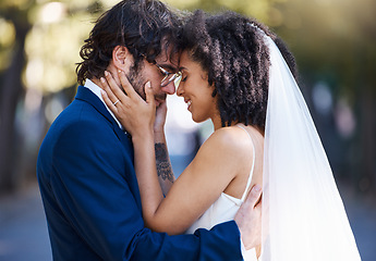 Image showing Love, happy couple and wedding hug outdoor at marriage celebration event with commitment. Interracial man and woman together at park with trust, partnership and gratitude with a touch on the face