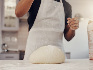 Image showing Chef man and flour sprinkle on dough for baking preparation work and process at culinary counter. Restaurant worker in professional kitchen preparing wheat bread, cake or pizza recipe.