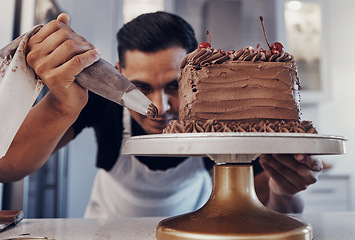 Image showing Piping, chef and man baker baking a cake with chocolate in a kitchen or pastry cook preparing a sweet recipe. Food, dessert and cook preparing a sweet meal in Brazil and adds cream or icing