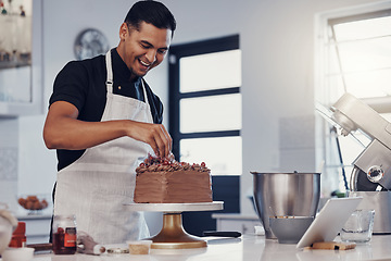 Image showing Chef, baking and cake with chocolate in a kitchen by a happy man preparing a sweet desert or a birthday. Decoration, baker or cook with a small business smiling and cooking dessert at a bakery