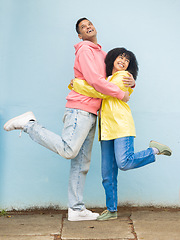 Image showing Happy, rain jacket and couple of friends hug with a smile and love for winter weather with happiness. Date, romance and pavement together outdoor with friendship and care excited about hugging