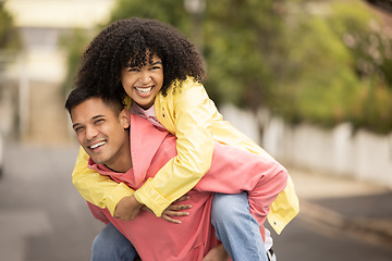 Image showing Black couple, smile and piggyback of young people with love, care and freedom in a street. Urban, happy and free woman and man together with a holiday and happiness hug loving summer fun outdoor