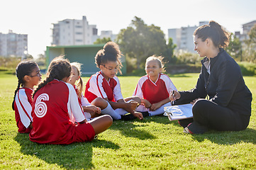 Image showing Clipboard, soccer or coach with children planning for strategy, training or sports goal in Canada. Team building, friends and woman coaching group of girl on football field for game, match or workout