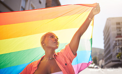 Image showing Lesbian, pride and black woman in city with flag for lgbtq community, ally or gay with support and equality in love outdoor. Rainbow, parade and lgbt awareness, inclusion and celebrate with sexuality