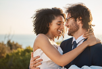 Image showing Marriage, interracial couple and love hug in nature of people happy about trust and commitment. Outdoor carrying, sea and mock up at wedding with smile from bride and man in suit at partnership event