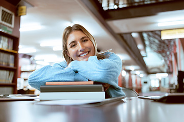 Image showing Portrait, woman and student in library, studying and higher education for knowledge, growth or learning. University, female academic or lady with books, smile or relax with scholarship or information