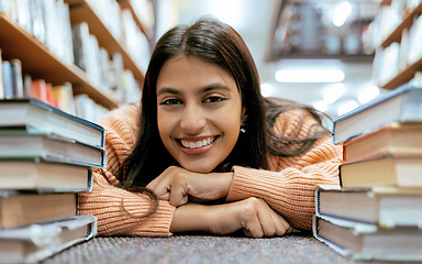 Image showing Portrait, Indian woman on floor and books to relax, smile and hobby for learning, growth and education. Student on ground, female or academic in library, knowledge and rest after studying and college