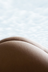 Image showing Sexy, nude and butt of a woman against a cloudy sky in nature, relax and erotic on the beach in Bali. Sexy, naked and body skin of a beautiful, carefree and relaxing person at the sea during holiday