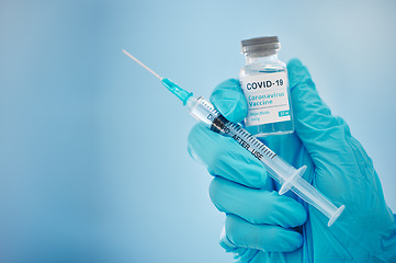 Image showing Doctor, hands and covid vaccine for cure, healthcare or medical syringe medication to combat the virus. Hand of nurse holding corona virus sample with needle for vaccination from illness or disease