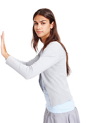 Image showing Portrait, push and mockup with a woman in studio isolated on a white background for effort or moving. Mock up, poster or billboard with an attractive young female pushing blank space for presentation