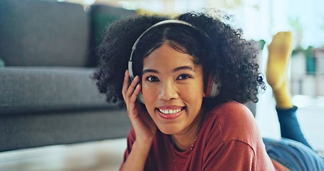 Image showing Music, laptop and relax girl on floor carpet streaming radio rap, disco or rock song while singing trendy audio. Headphones, energy or student black woman listening to wellness sound and typing on pc