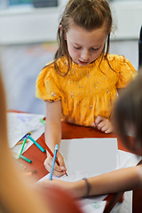 Image showing Creative kids sitting in a preschool institution, draw and have fun while they get an education