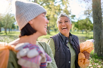 Image showing Happy, friends and community cleaning project in park by women for charity, recycling or environment cleanup. Volunteers, senior and young woman bonding while walking in forest volunteering together