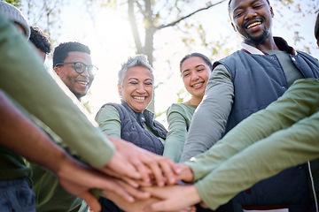 Image showing Teamwork, motivation and huddle with senior friends hiking together in the forest or woods from below. Fitness, exercise or nature with a mature man and woman friend group putting hands in a circle