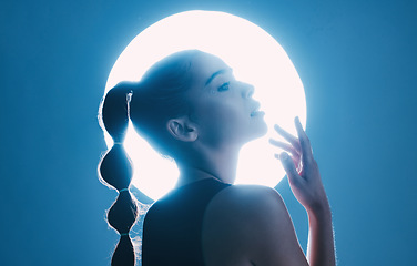 Image showing Magical, beautiful and face of a girl with lighting isolated on a dark background in a studio. Idea, creative and woman thinking of futuristic glow from light, art and cosmetics on a backdrop