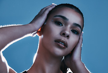 Image showing Face portrait, beauty skincare and woman in studio isolated on a blue background. Makeup light, cosmetics and aesthetics of female model satisfied after facial treatment for healthy and glowing skin.