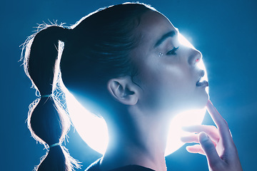 Image showing Makeup, cyberpunk and face of a girl with lighting isolated on a dark background in a studio. Idea, creative and woman thinking of futuristic glow from light, art and cosmetics on a backdrop