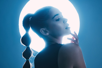 Image showing Thinking, cinematic and face of a girl with a spotlight isolated on a dark background in a studio. Idea, creative and woman with a futuristic glow from light, art and cosmetics on a backdrop