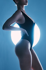 Image showing Sexy, erotic and body of a woman with a spotlight isolated on a dark background in a studio. Fashion, curves and butt of a model posing for sensuality, seductive and stylish energy on a backdrop