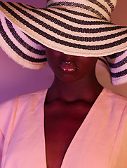 Image showing Fashion, beauty and woman in neon light, UV and purple studio background wearing a sun hat. Style, makeup and African American female model with dark skin aesthetic creativity, color and design