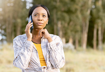 Image showing Black woman, phone and thinking on call in nature for communication, travel or cellular 5G service outdoors. African American female contemplating trip, traveling or decision on smartphone