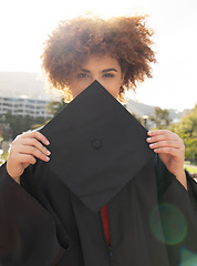 Image showing University student girl, portrait and graduation cap to hide face with success, achievement and goal. Black woman, graduate celebration and vision in education, learning and future career in sunshine