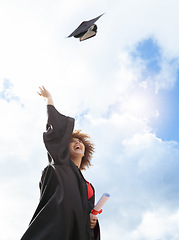 Image showing Black woman, graduation and cap in air for celebration, happiness or success with diploma for studying at campus. University student, gen z girl and happy for goal, vision and achievement at academy