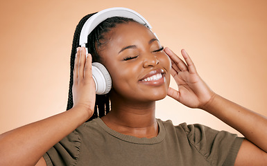 Image showing Headphones, music and african woman isolated on studio background for mental health, energy and wellness podcast. Happy, calm black people listening to audio with smile on face for stress free sound