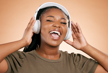 Image showing Headphones, singing and portrait of woman isolated on studio background in mental health, energy and radio music. Singer, voice and gen z black people listening to sound, audio technology on mockup